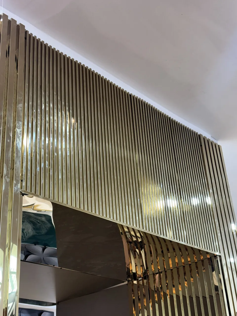 Fluted gold stainless steel feature wall at an exhibition