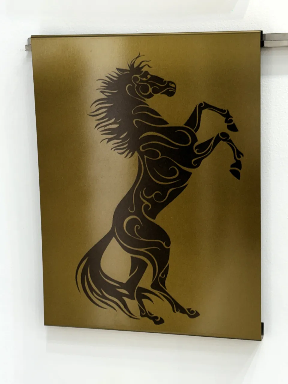 Custom etched horse artwork on a gold stainless steel sheet