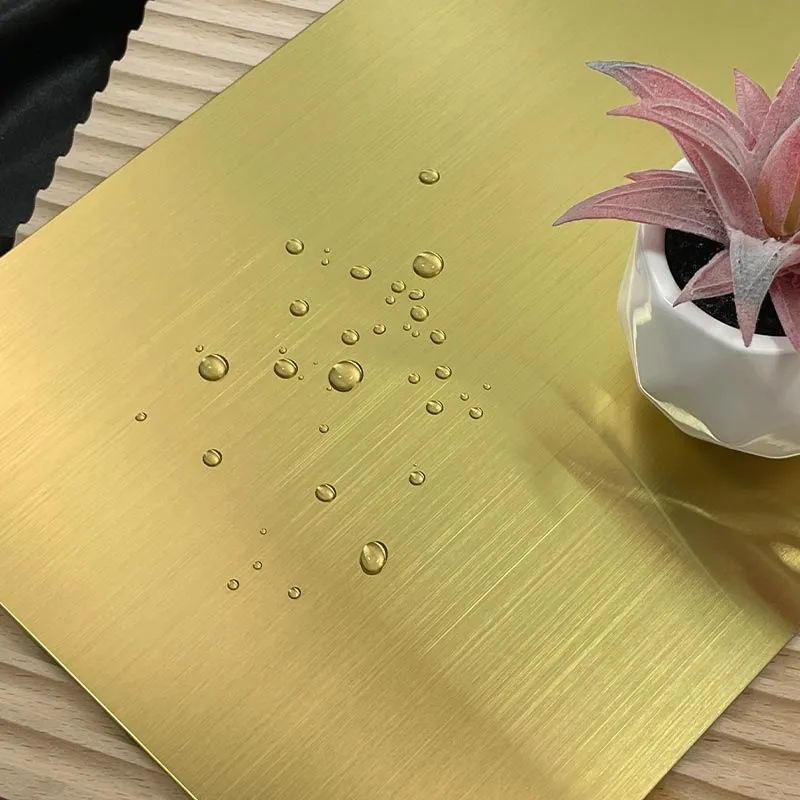Gold hairline stainless steel sheet with water droplets on the surface